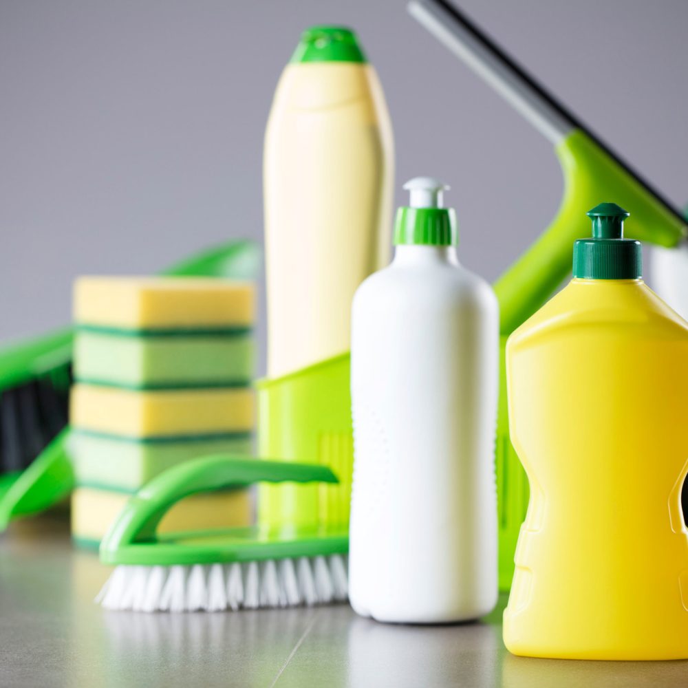 House and office cleaning up theme.  Set of colorful cleaning products on gray background.